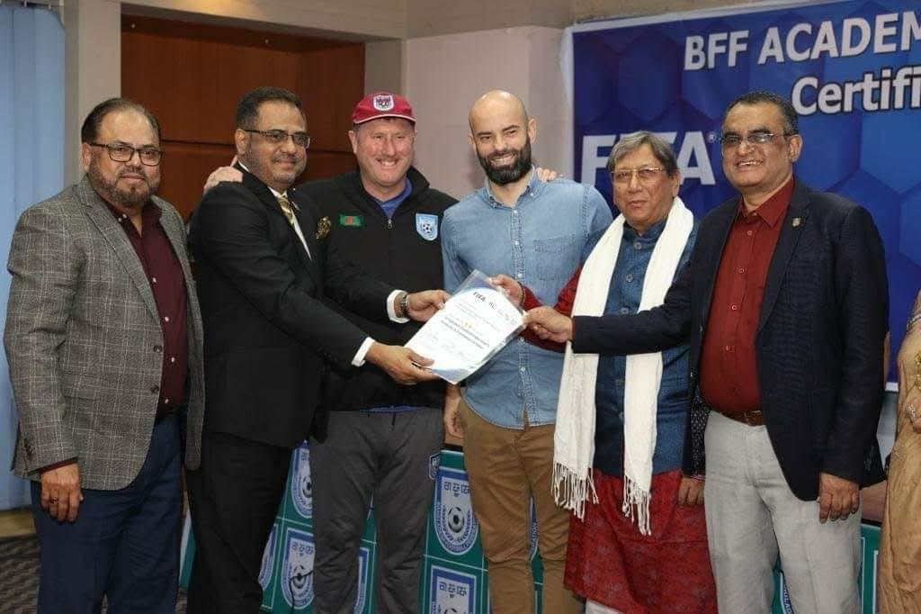 Md. Nurul Mannan Choudhury with the Bangladesh National Football Team coaching staff and players on the field